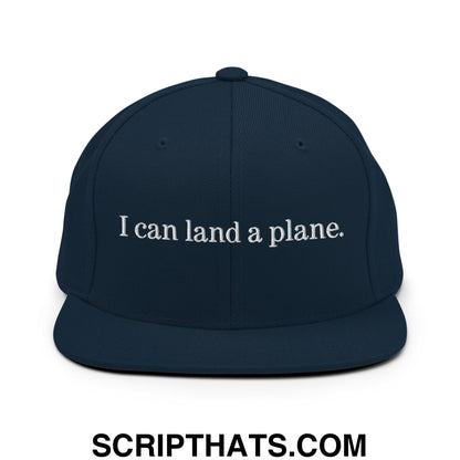 Navy blue snapback hat with white embroidered i can land a plane text and flat bill brim design