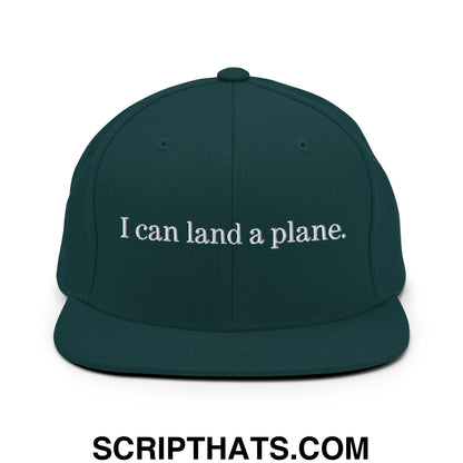 Dark green snapback hat with white embroidered i can land a plane text and flat bill brim design