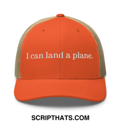 Orange trucker hat with beige mesh back and white embroidered text i can land a plane embroidery
