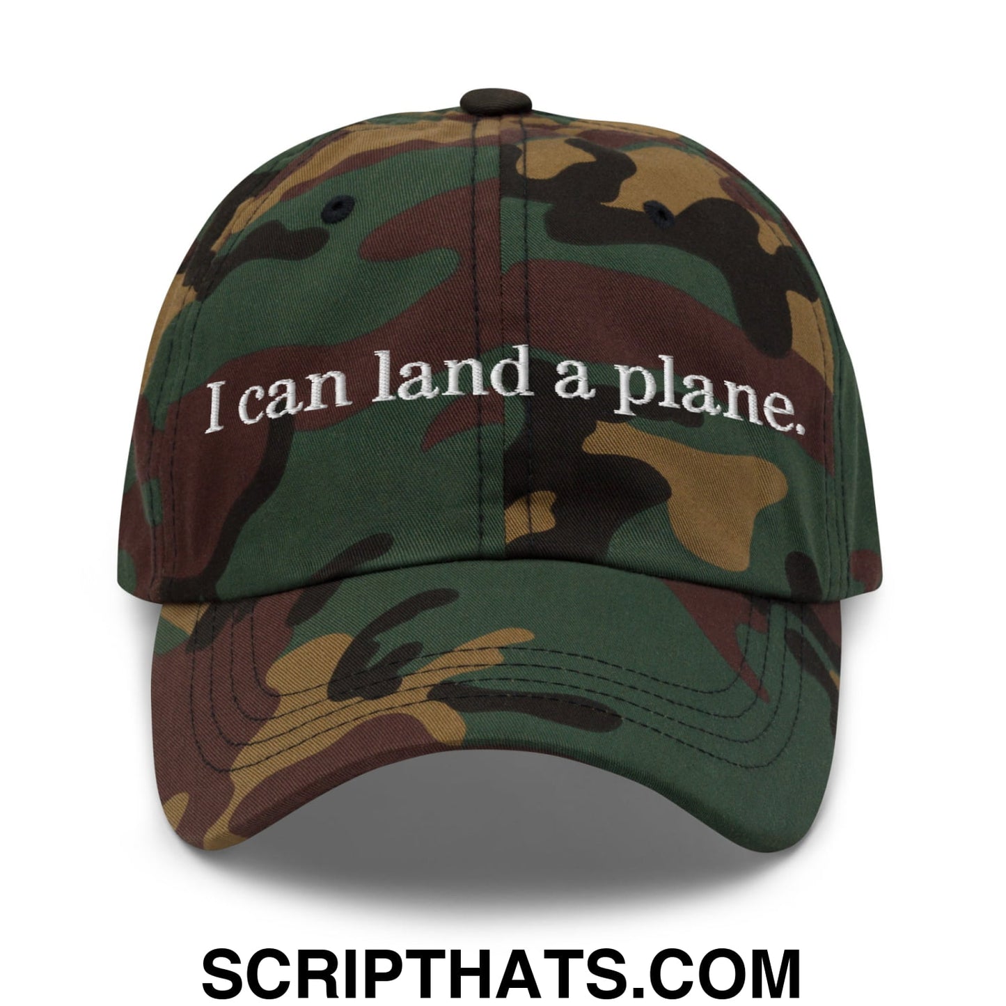 A camouflage unstructured dad hat with white embroidered text reading i can land a plane on the front