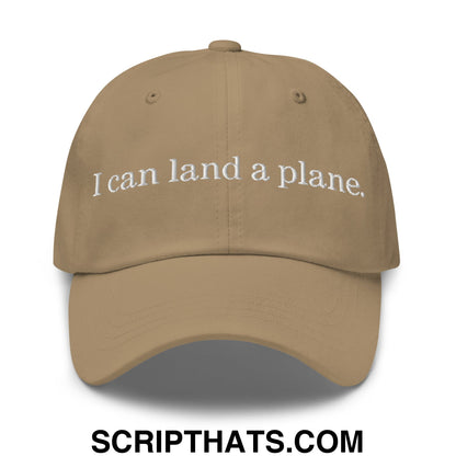 Tan unstructured dad hat with white embroidered text i can land a plane featuring a casual baseball cap design