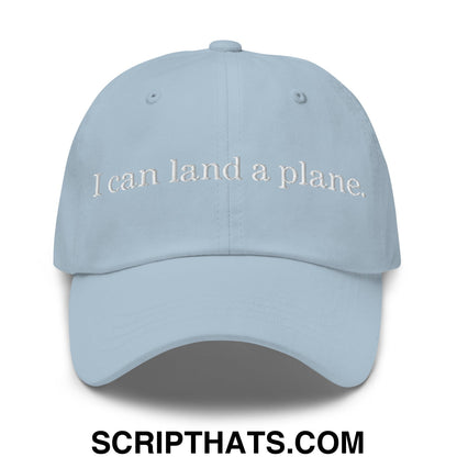 Light blue unstructured dad hat with white embroidered text i can land a plane for casual wear