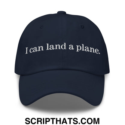 Navy blue unstructured dad hat with white embroidered text i can land a plane in a casual style