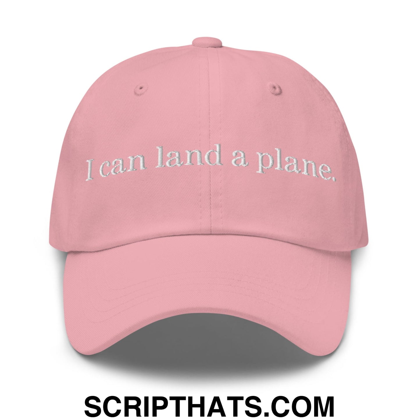 A soft pink unstructured dad hat with white embroidered text i can land a plane perfect for casual wear