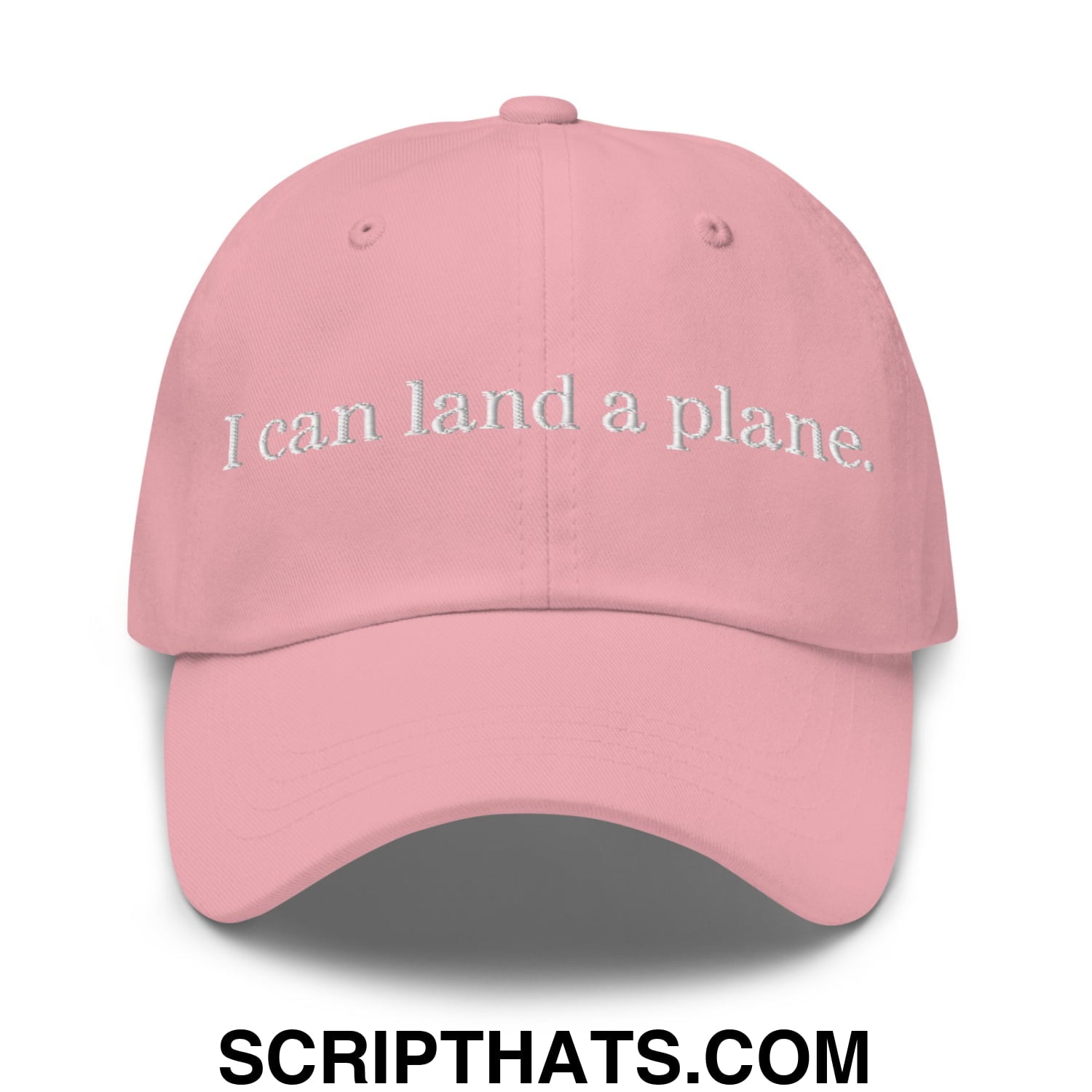 A soft pink unstructured dad hat with white embroidered text i can land a plane perfect for casual wear