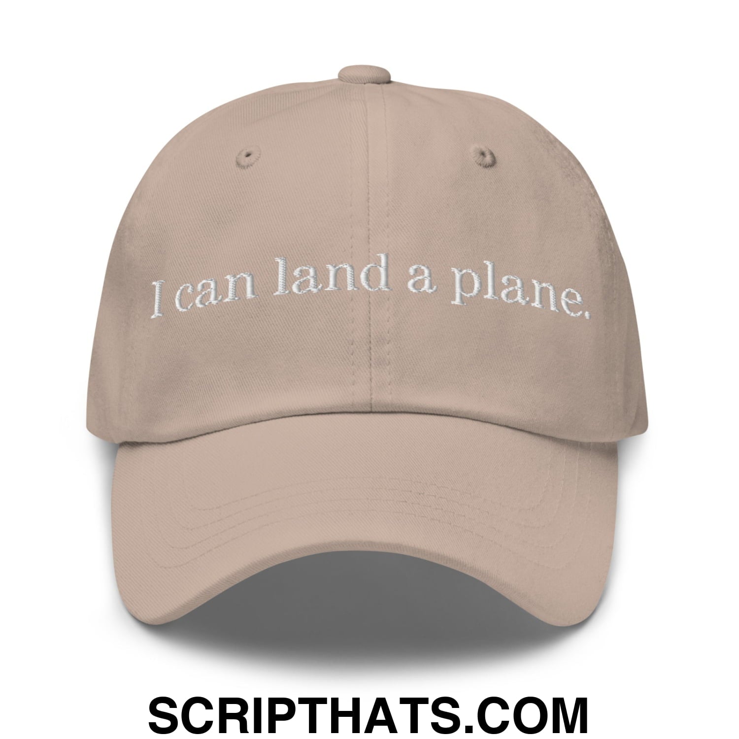 Beige unstructured dad hat with white embroidered text reading i can land a plane in casual cotton fabric