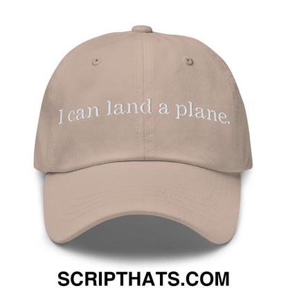 Beige unstructured dad hat with white embroidered text reading i can land a plane in casual cotton fabric