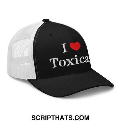 Black and white mesh trucker hat with embroidered i heart toxic text in silver thread and a red heart symbol