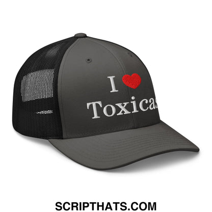 Dark gray trucker hat with black mesh back featuring white embroidered i heart toxicas text and red heart symbol