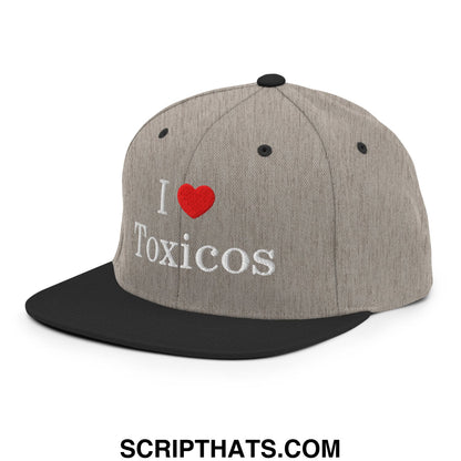 Gray and black snapback hat with i heart toxicos embroidered in white and red on a heathered fabric crown and flat brim