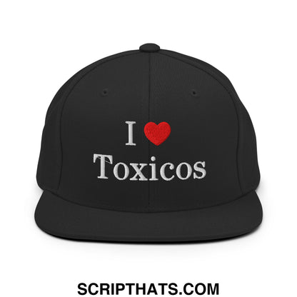 Black snapback hat with embroidered white text i heart toxicos and red heart featuring a flat bill brim