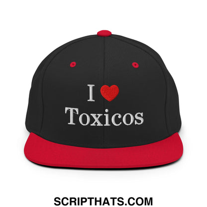 Black and red snapback cap with white embroidered i heart toxicos text on the front flat bill brim design