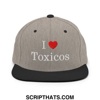 Gray snapback hat with black brim and embroidered i heart toxicos in white lettering and red heart design