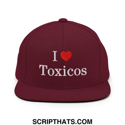 Maroon flat bill brim snapback hat with white embroidered i heart toxicos text and red heart symbol