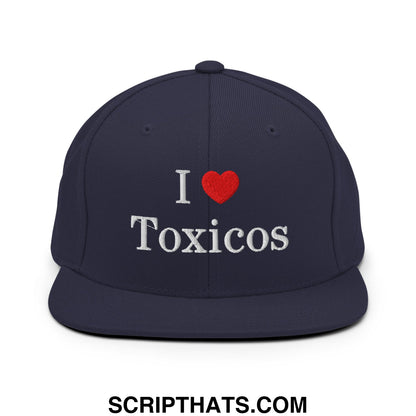 Navy blue flat bill snapback hat with white embroidered i heart toxicos text and a red heart symbol