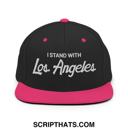 Black snapback cap with vibrant pink brim and silver embroidered i stand with los angeles text flat bill brim