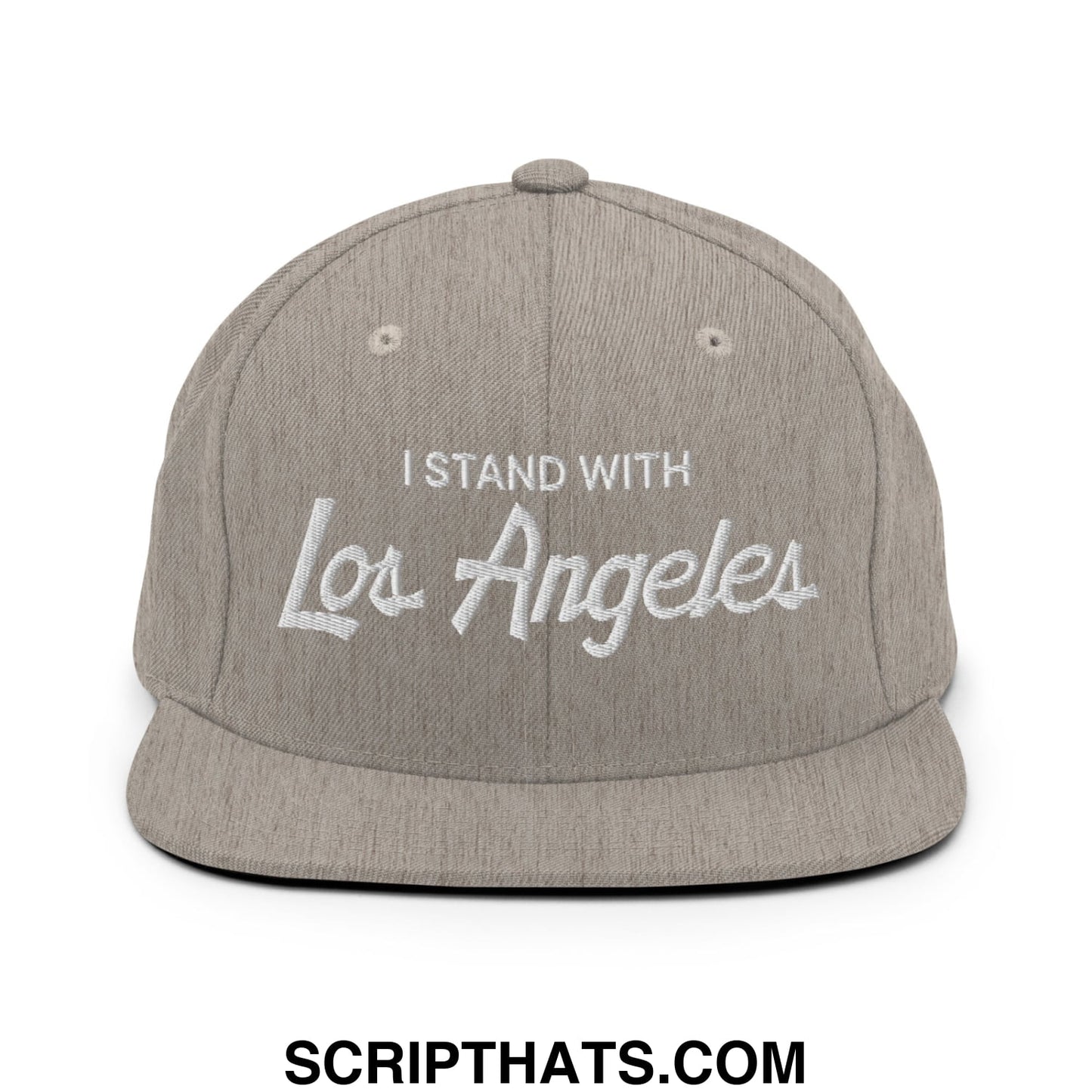 A gray snapback hat with white embroidered i stand with los angeles script text and flat brim design