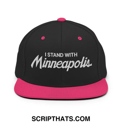 Black snapback cap with vibrant pink flat bill brim and button featuring white embroidered i stand with minneapolis text