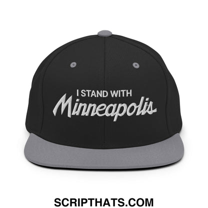 Black snapback cap with gray brim and white embroidered text i stand with Minneapolis in stylized script font