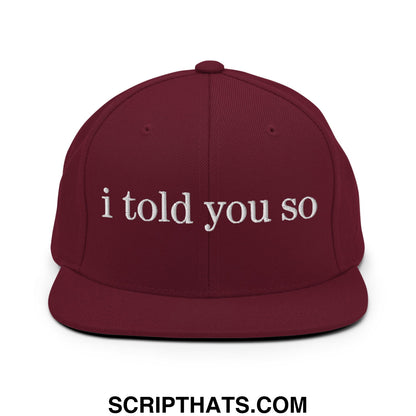 Maroon snapback cap with white embroidered i told you so text featuring a flat bill brim design