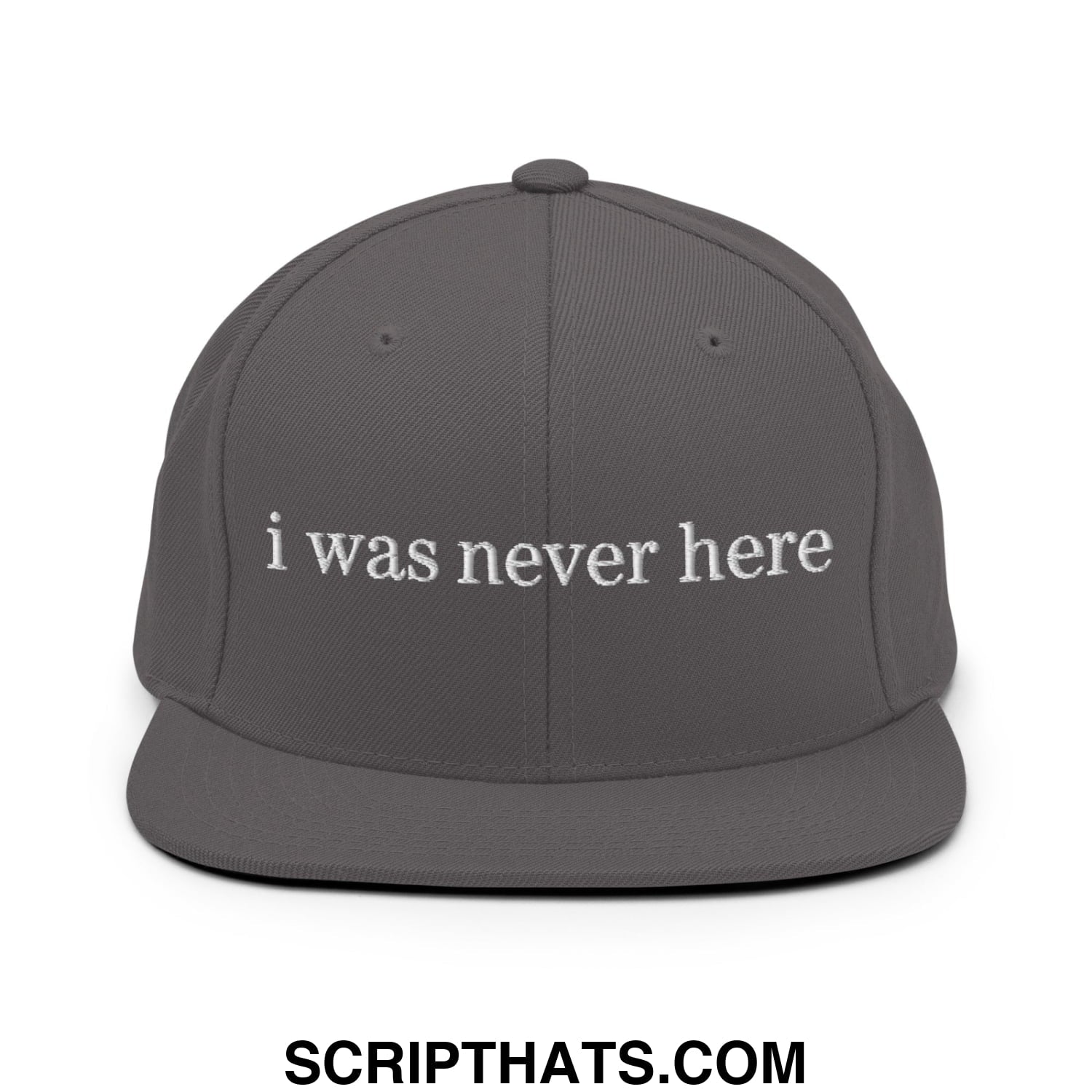A dark gray snapback hat with white embroidered i was never here text and a flat bill brim design
