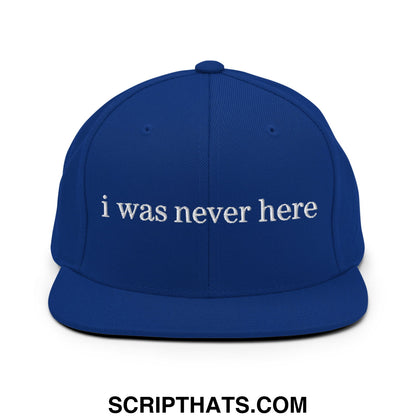Royal blue snapback hat with white embroidered i was never here text and flat bill brim design