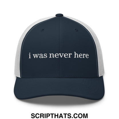 Navy blue and white mesh trucker hat embroidered with the text i was never here in a casual style