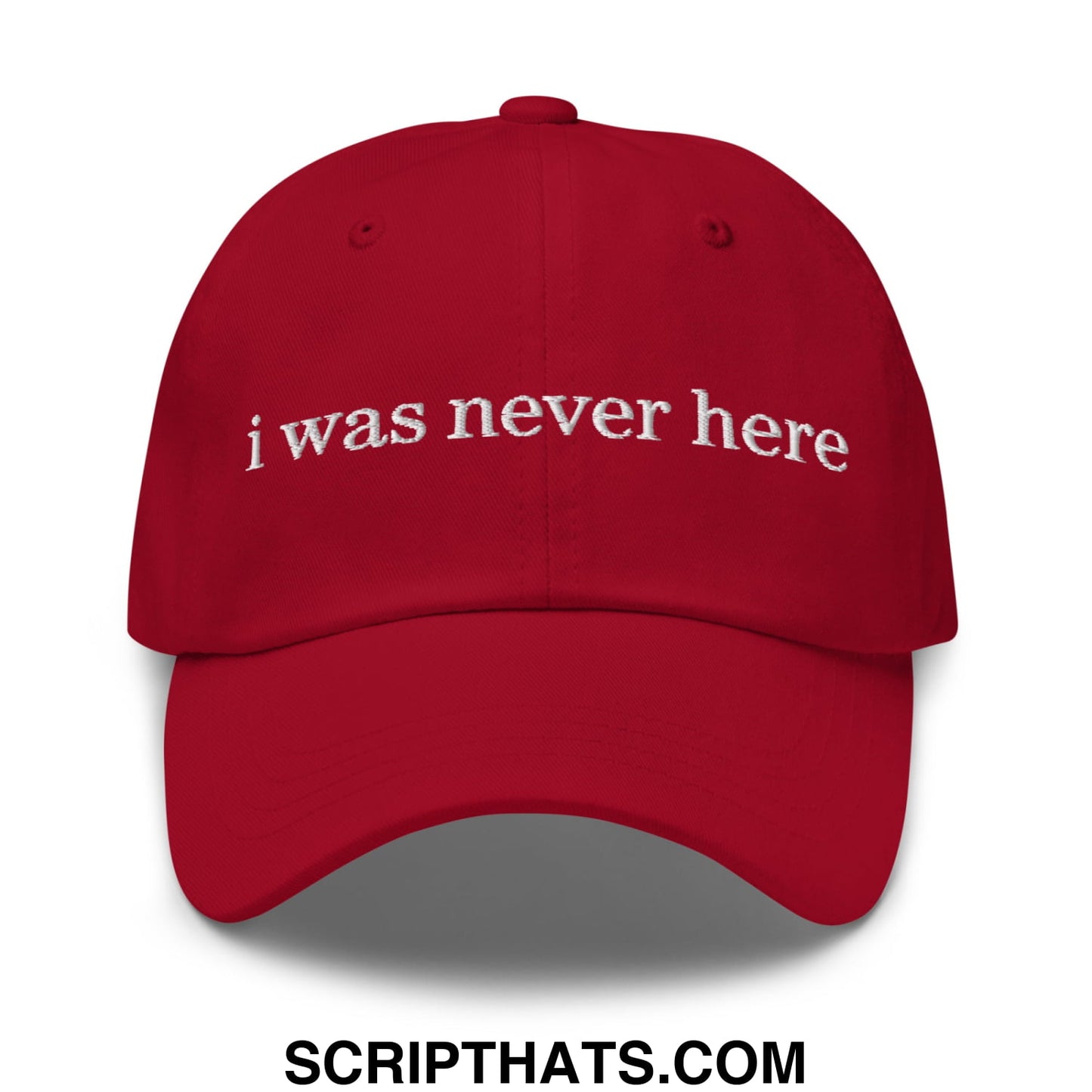 Red unstructured dad hat with white embroidered text i was never here on the front panel