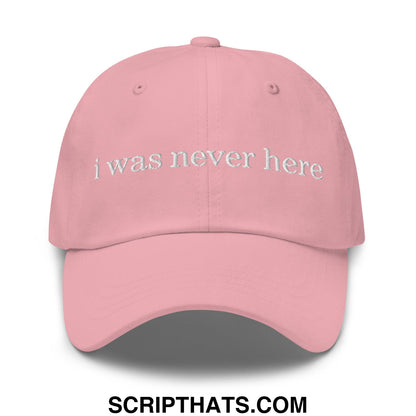 A soft pink unstructured dad hat with i was never here embroidered in white thread on the front