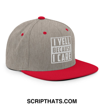 Gray and red snapback hat with flat bill brim featuring white embroidered i yell because i care graphic
