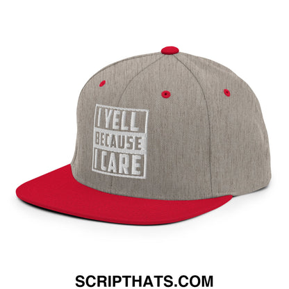 Gray and red snapback hat with white embroidered i yell because i care logo and flat bill brim design