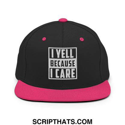 Black snapback cap with vibrant pink brim and white embroidered i yell because i care text on front in bold block letters