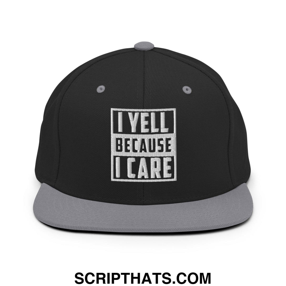 Black snapback hat with gray flat bill brim and white embroidered i yell because i care patch in bold block letters