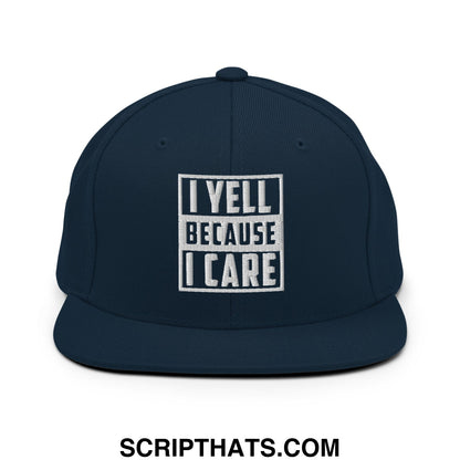 Navy blue snapback hat with white embroidered i yell because i care text in bold block font on the front panel