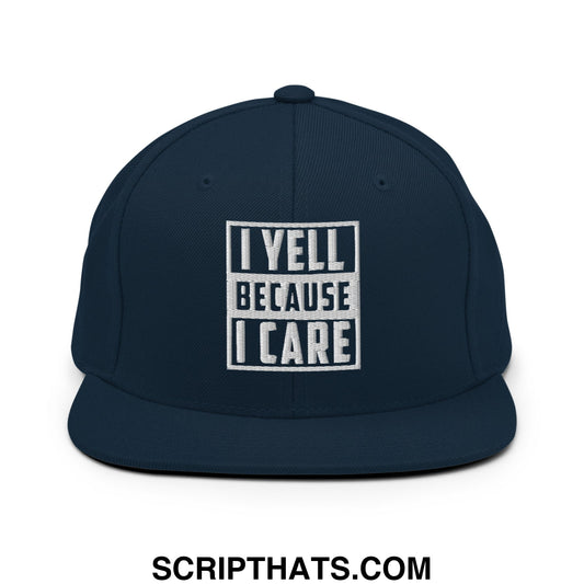 Navy blue snapback hat with white embroidered i yell because i care text in bold block font on the front panel