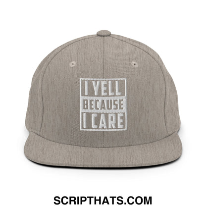Gray heathered snapback cap with white embroidered i yell because i care text inside a rectangular border