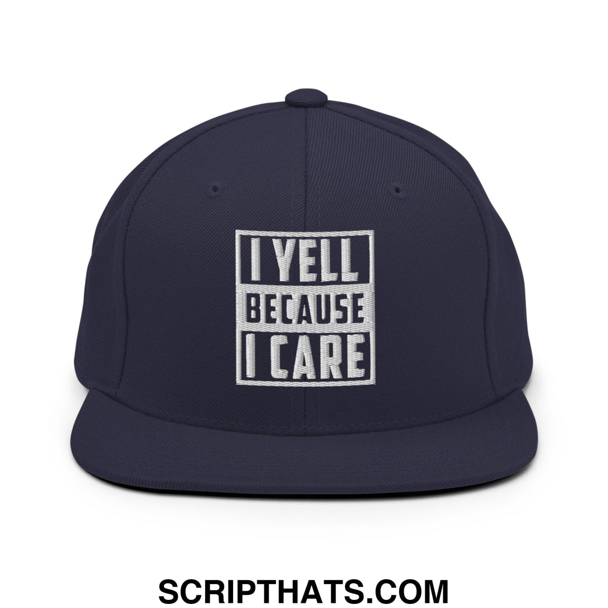 Navy blue snapback hat with white embroidered i yell because i care text in bold blocky font and flat bill brim