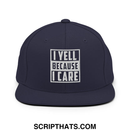 Navy blue snapback hat with white embroidered i yell because i care text in bold blocky font and flat bill brim