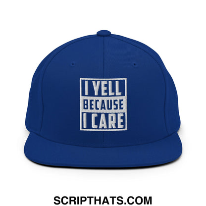 Royal blue snapback hat with white embroidered i yell because i care text in bold block font and flat bill brim