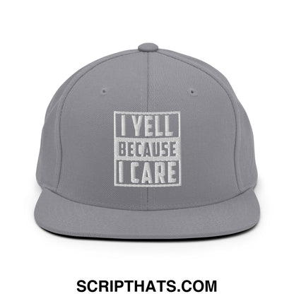 Gray snapback hat with white embroidered text i yell because i care inside a rectangular border flat bill brim