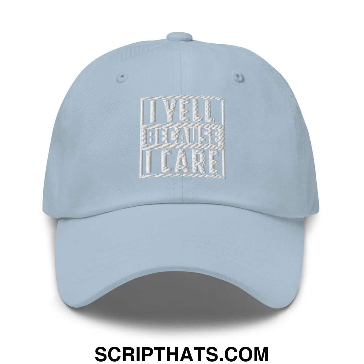 Light blue unstructured dad hat with white embroidered i yell because i care text inside rectangular border