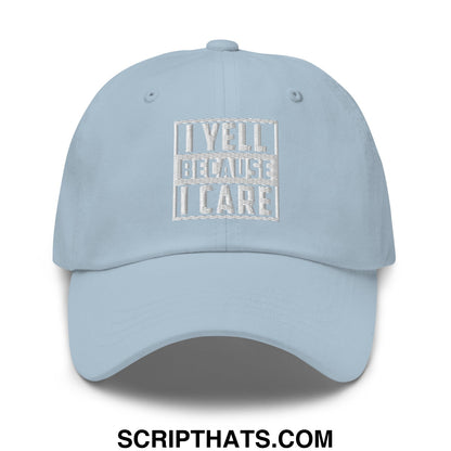 Light blue unstructured dad hat with white embroidered i yell because i care text inside rectangular border