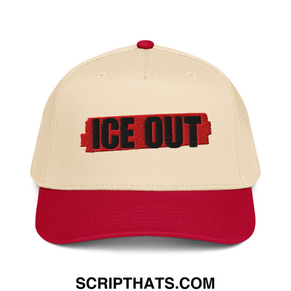 Beige and red ice out embroidered baseball snapback hat on textured red background