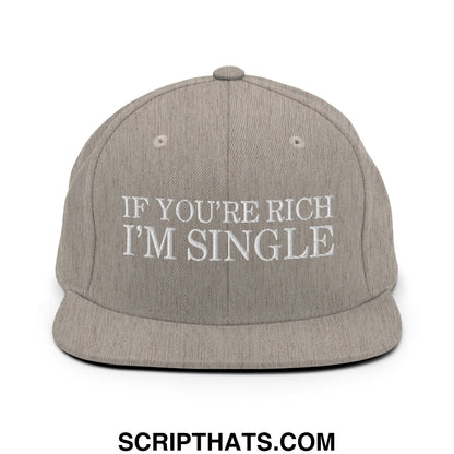 A gray snapback hat with a flat bill and white embroidered text reading if youre rich im single