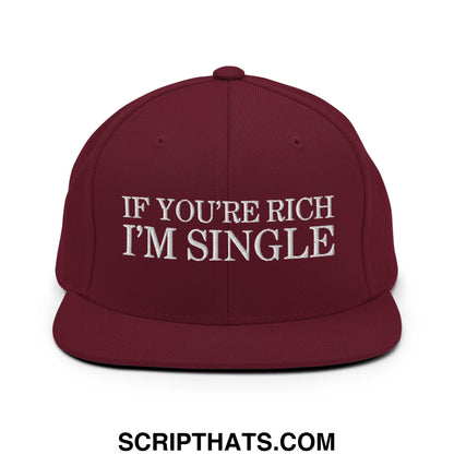 Maroon snapback hat with white embroidered if you’re rich i’m single text and flat bill brim design