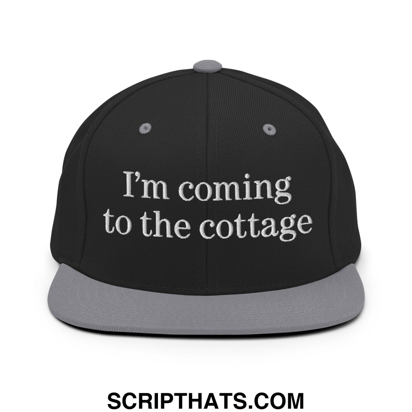 Black snapback cap with gray brim and white embroidered text saying im coming to the cottage flat bill brim hat