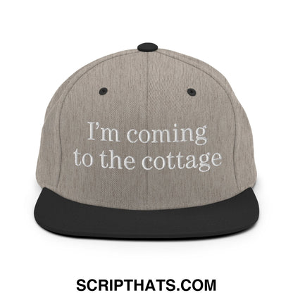Gray and black snapback cap with white embroidered text reading I’m coming to the cottage flat bill brim design