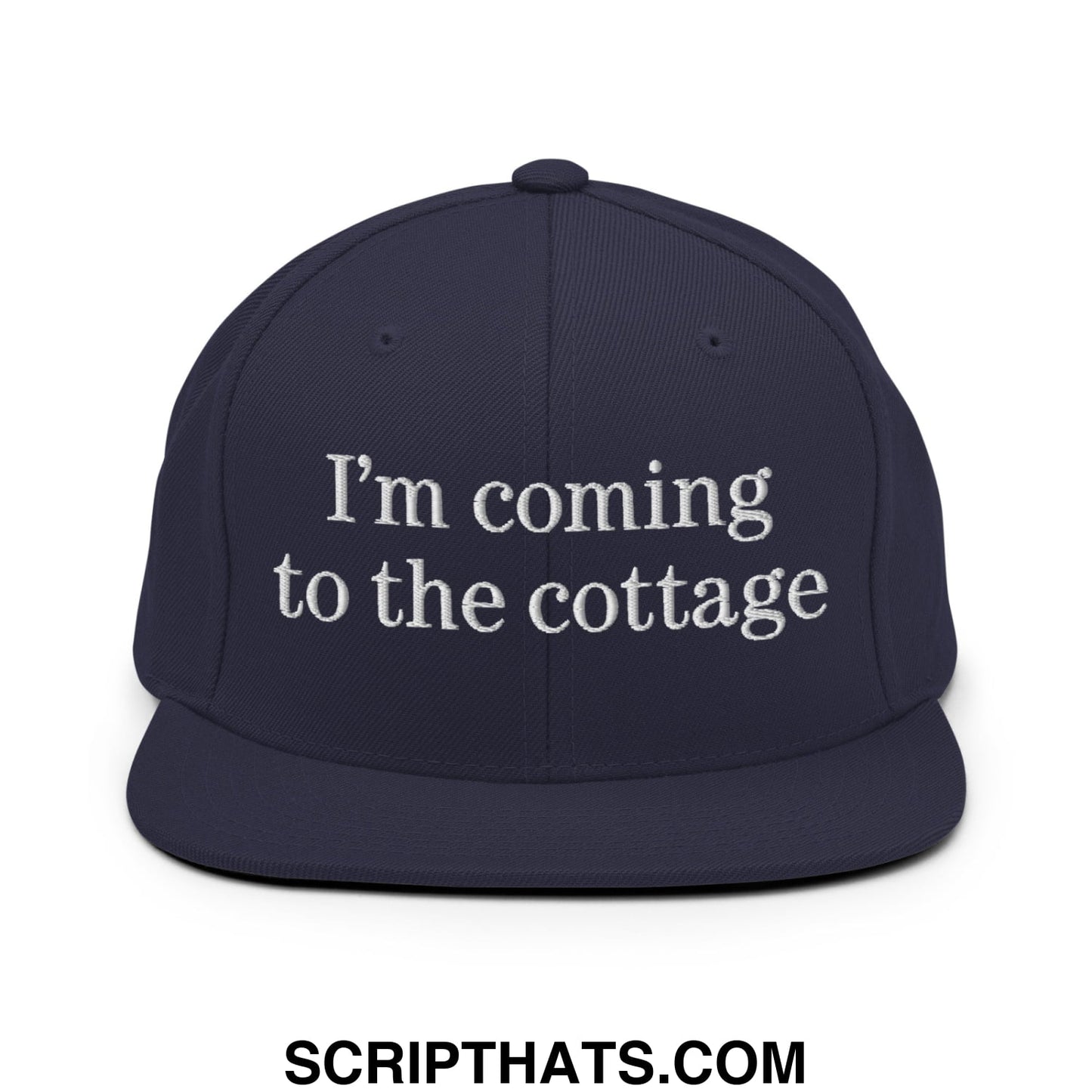 Navy blue snapback hat with white embroidered text im coming to the cottage flat bill brim design