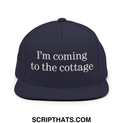 Navy blue snapback hat with white embroidered text im coming to the cottage flat bill brim design