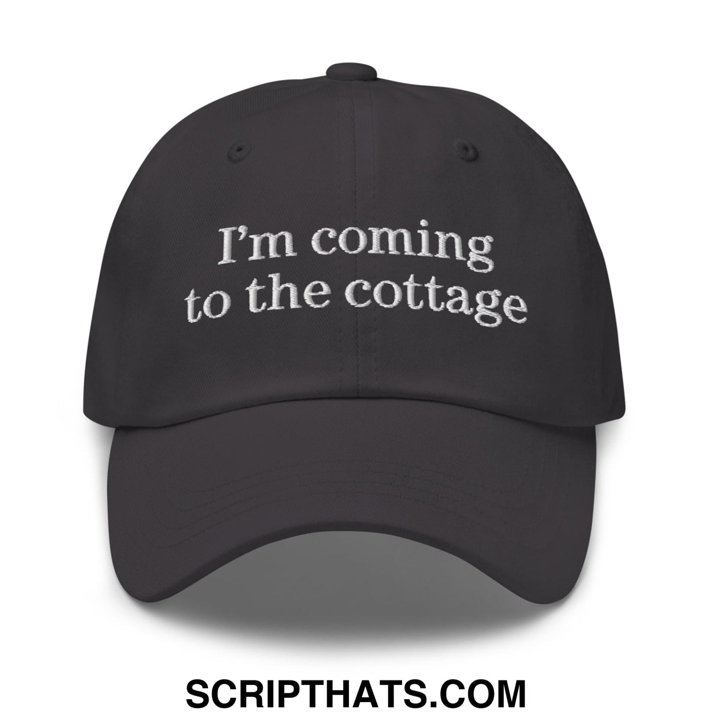 Black unstructured dad hat with white embroidered text im coming to the cottage ideal for casual outdoor wear